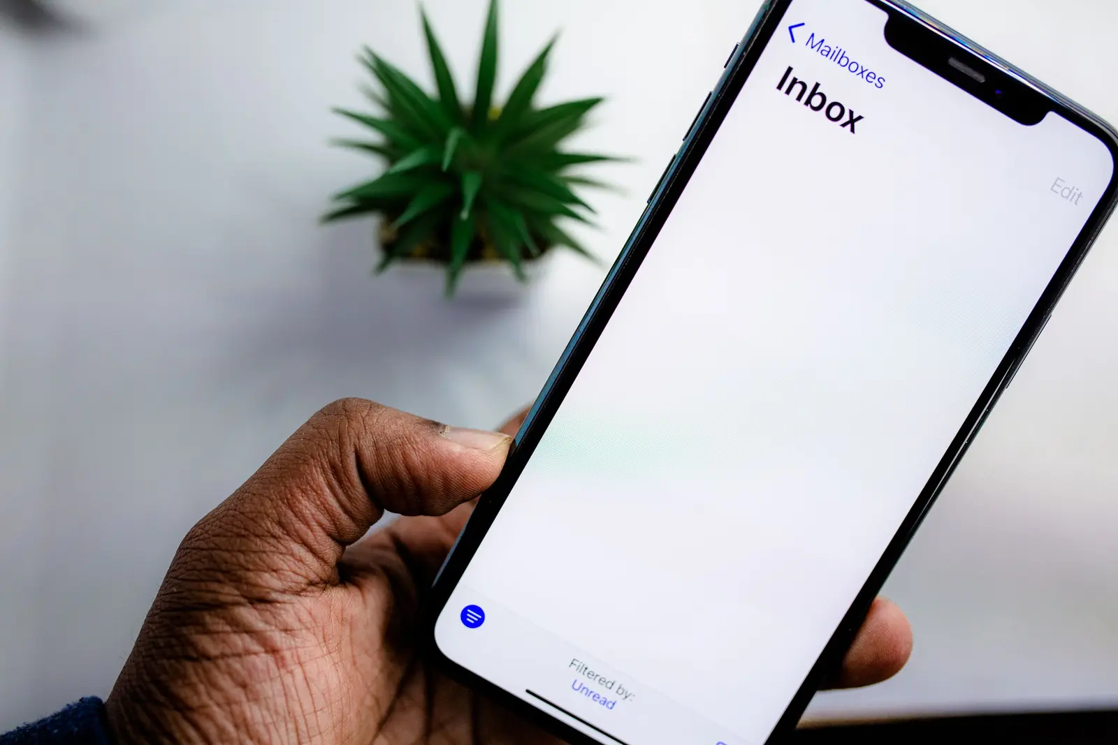 A phone showing an email inbox