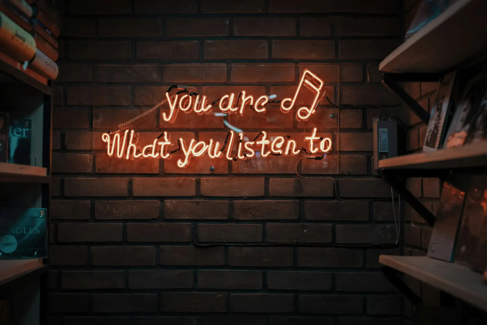 A neon sign reading you are what you listen to